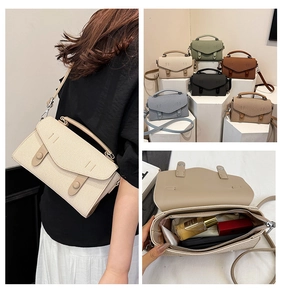 Detail view of woven texture crossbody bag with adjustable strap and interior storage