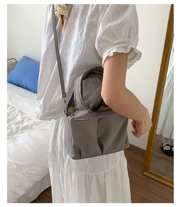 Grey nylon tote bag detail with round handles and adjustable shoulder strap for women