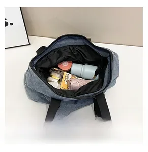 Top-down view of blue denim tote bag interior showing large storage capacity for essentials