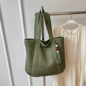 Olive green straw tote bag with woven mesh design and tassel for beach summer style