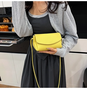 Detail of yellow lychee textured crossbody bag styled in a modern lifestyle setting