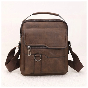 Detailed view of brown retro leather shoulder bag with zipper pocket and metal D-ring