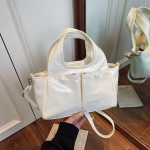 Chic cream white crossbody handbag with dual front pockets and glossy mirror finish