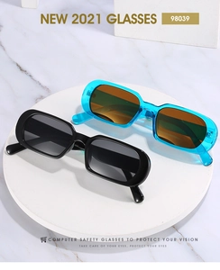 Close-up of retro oval sunglasses with thick jelly frames in black and transparent blue