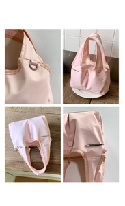Detail view of pink nylon handbag featuring silver D-ring hardware and knitted trim