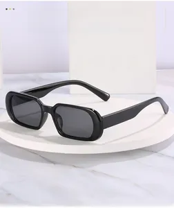 Close-up of retro oval sunglasses with black frames on a marble display stand