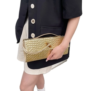 Metallic gold woven baguette handbag with top handle and slim detachable shoulder strap