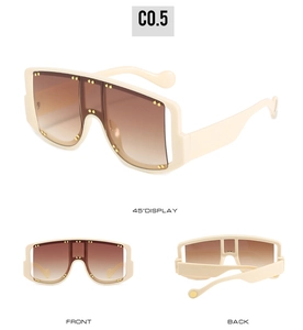 Detailed views of creamy white oversized sunglasses with gold rivets and brown gradient lenses