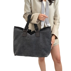 Large dark grey canvas tote bag with black strap handles and silver metal rings