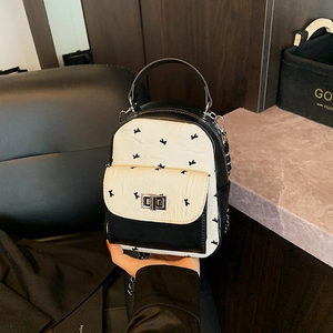 Chic black and white quilted mini backpack with silver metal lock and chain strap