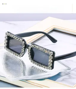 Detailed view of oversized square sunglasses with crystal rhinestones on black frame