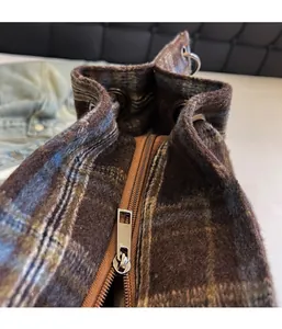 Detail view of the metal zipper closure on a vintage plaid corduroy handbag for women