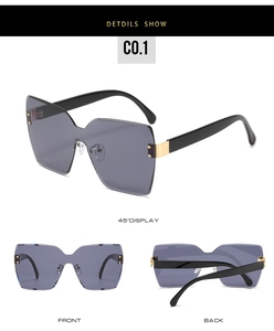 Detailansicht der übergroßen randlosen Butterfly-Sonnenbrille mit grauen Gläsern und Nieten