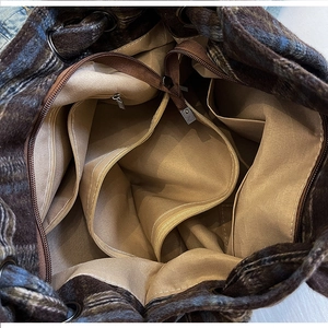 Internal view of corduroy tote bag showing zipper pockets and spacious compartments
