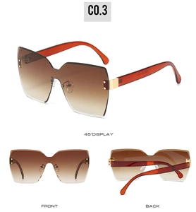Detailansichten der braunen randlosen Oversize-Sonnenbrille mit bernsteinfarbenen Bügeln