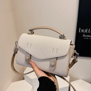 Minimalist canvas and leather tote bag featuring a chic contrast design and top handle
