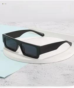 Detail of classic black square sunglasses with thick temples on a premium stone background