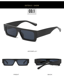Detail view of bold square black sunglasses with thick frames and dark lenses