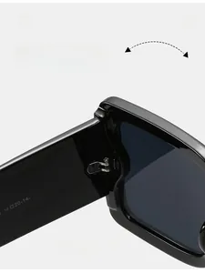 Detail of durable metal hinges on trendy thick black oversized square sunglasses