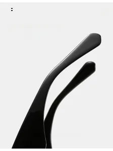 Detail of ergonomic curved glossy black sunglasses legs with high-light texture finish