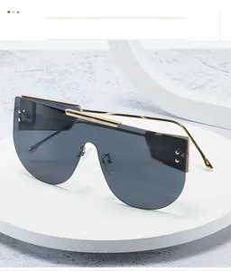 Detailed close-up of dark grey shield lens and gold metal frame on pedestal