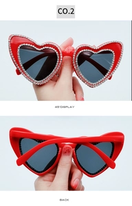 Detailed view showing sparkling rhinestone trim on red heart-shaped frames from back and side