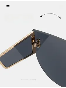 Macro shot of durable golden metal hinges on oversized shield sunglasses frame