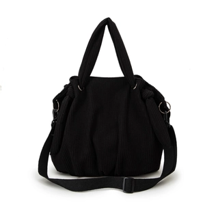 Fashionable black corduroy hobo bag with adjustable wide strap and pleated details