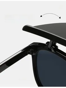 Detail of durable textured metal hinges on stylish black flip-up sunglasses for women