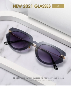 Detail of trendy purple gradient sunglasses with gold metal bridge and sleek black frame