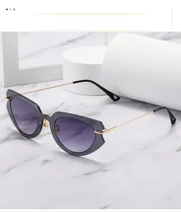 Detail of cat-eye sunglasses with marble texture frame and purple gradient lenses