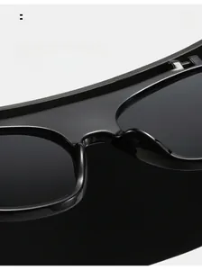 Close-up of comfortable integrated nose pads on black glossy oversized sunglasses