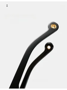 Detail of curved black mirror legs with golden trim holes for comfortable eyewear fitting