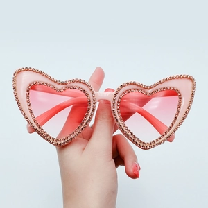 Pink heart-shaped rhinestone sunglasses with champagne crystals and tinted lenses