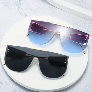 Oversized one-piece lens sunglasses with gold metal bridge and gradient lenses