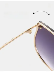 Detail of durable metal hinges on trendy sunglasses with gold frame and gradient lenses
