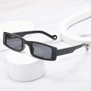 Trendy rectangular black frame sunglasses with grey lenses and gold metal leg accents