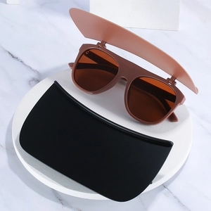 Unique flip-up sunglasses with brown matte frames and extra black lens for Saudi vacation