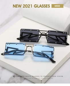 Detail view of square frame sunglasses with silver rivets and blue or grey lenses
