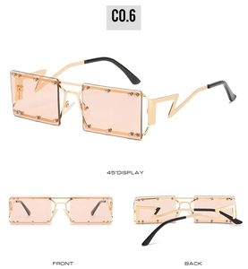 Detail view of square sunglasses with gold lightning temples and pink tinted lenses