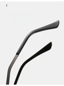 Detail of curved sunglasses legs with metal hinge and black comfort tips