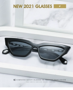Detailed macro view of trendy black cat-eye sunglasses with protective gray lenses