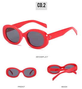 Detail view of red oval sunglasses featuring silver triple-dot rivets and UV lenses
