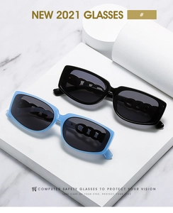 Detail of square sunglasses with chunky chain link arms in black and light blue