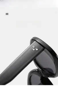 Close-up of black sunglass temples with silver dot accents and lightweight elastic texture