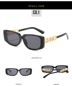 Detail view of square black sunglasses featuring unique golden metal chain temple design