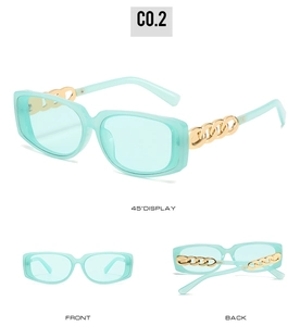 Detail view of mint green rectangular sunglasses featuring gold chain link temples