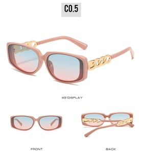 Detail view of pink square sunglasses featuring golden metal chain elements and gradient lenses