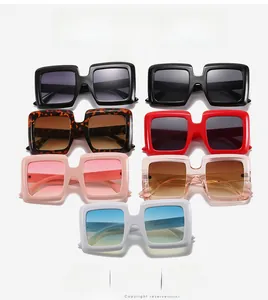 Multiple oversized square sunglasses in assorted colors like black, red, and tortoise shell