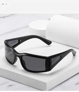 Detail view of matte black Y2K sports sunglasses on a premium marble and white pedestal